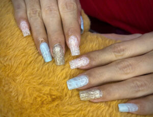 Gold silver and pale blue nail design at Fame Nails District 7