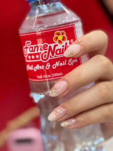 Nude glitter manicure at Fame Nails District 7