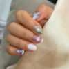 Purple green swirl and glitter nails at Fame Nails District 7
