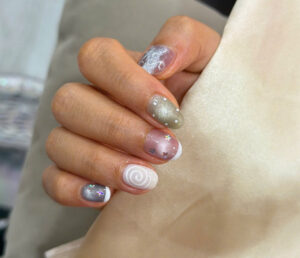 Purple green swirl and glitter nails at Fame Nails District 7