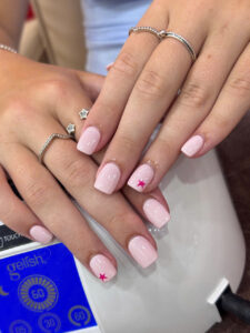 Soft pink star accent nails at Fame Nails District 7